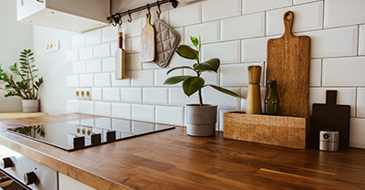 Kitchen with white tiles and wooden counters