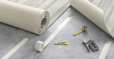 Rolls of carpet being fitted