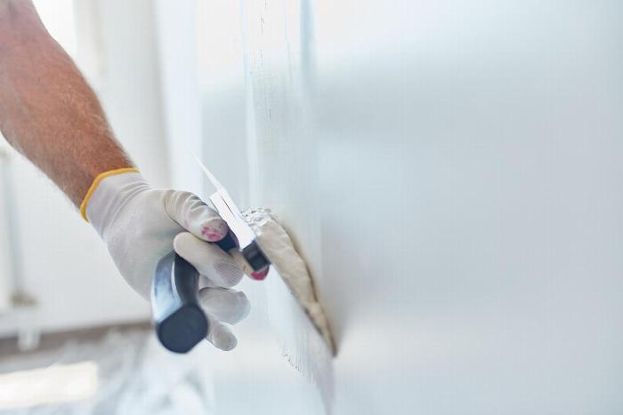 Handyman plastering a wall