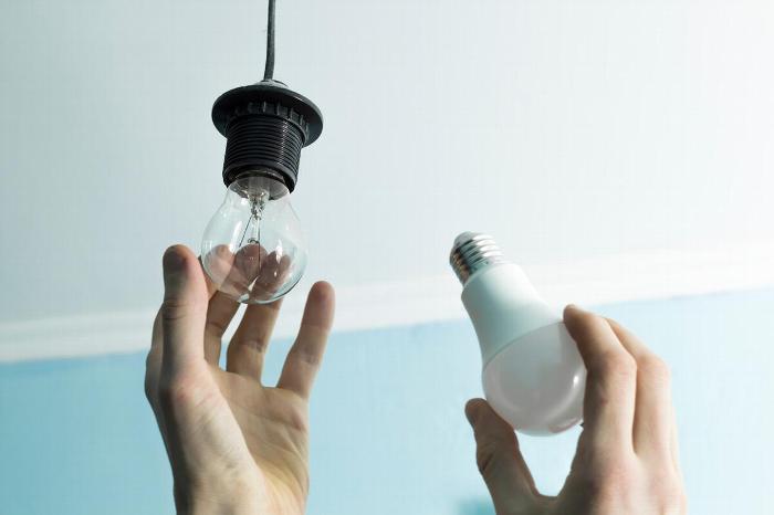 Handyman changing lightbulb