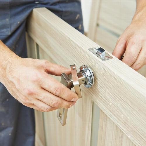 Handyman changing door handle